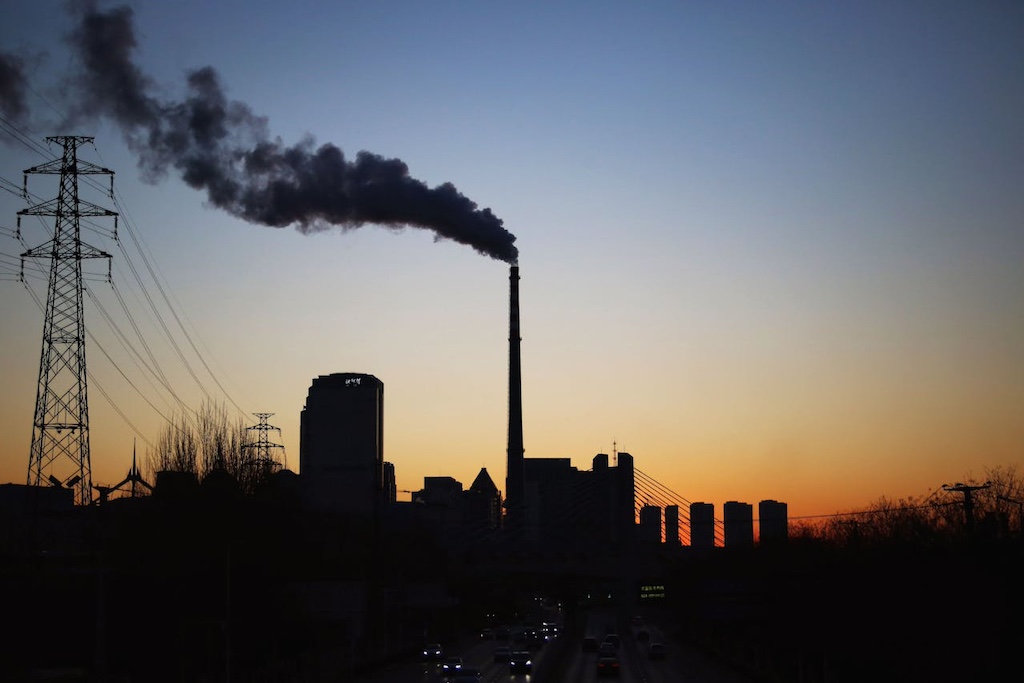industrial smokestack at sunset silhouette
