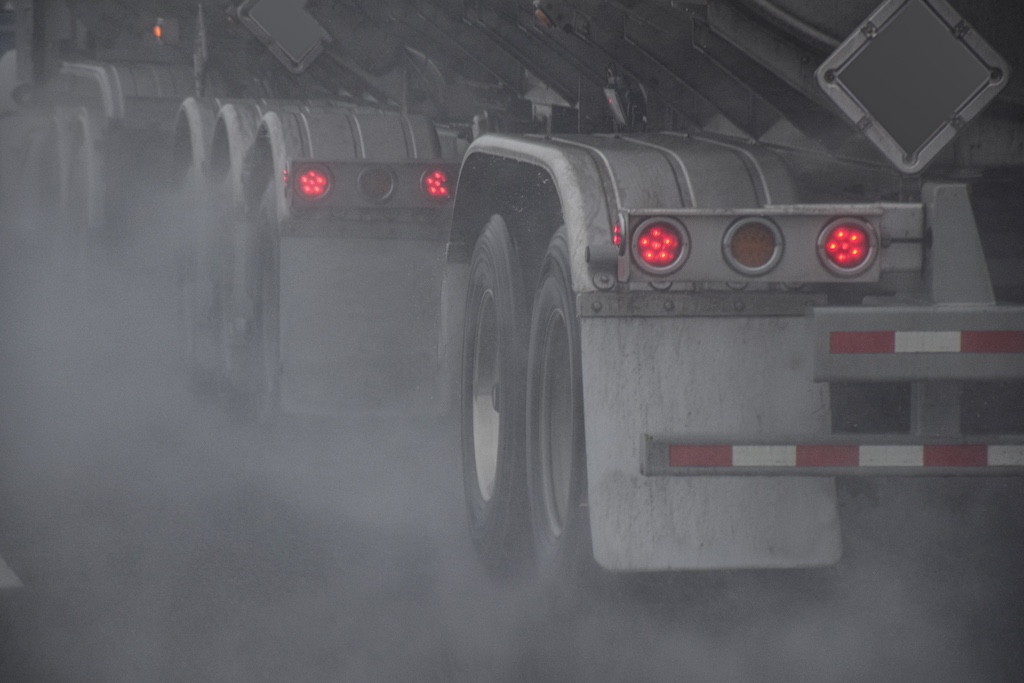 wheels of tractor trailer driving on a highway