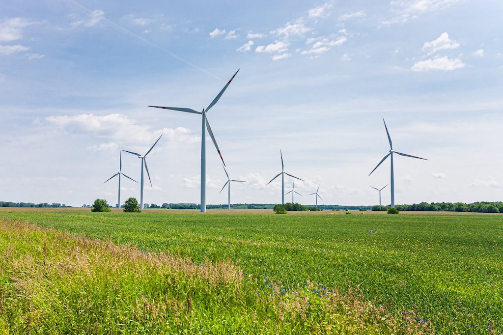 wind turbines on green grass field