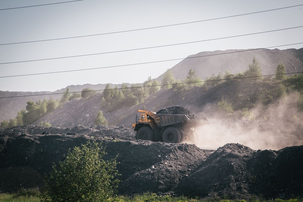 truck carryin stones on construction site in mountains