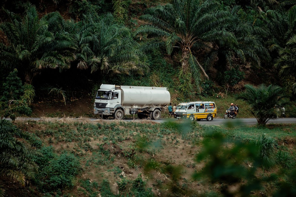 tanker truck on rural roadside with vehicles