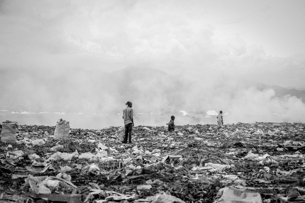 grayscale-photo-of-people-in-the-landfill-site grayscale photo of people in the landfill site